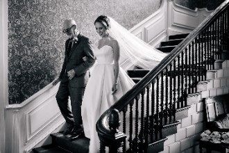 Bride and Father of the bride walking down stairs at Ardington House