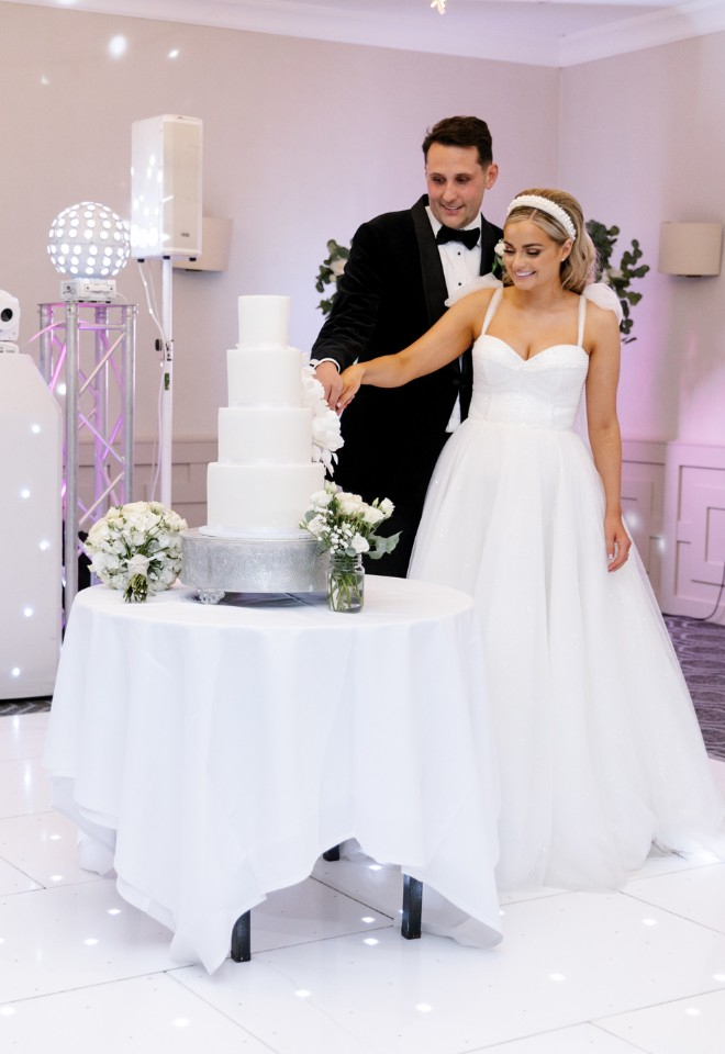 Bride and groom cut their wedding cake