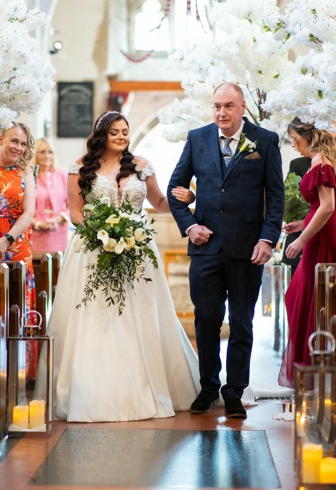 Bride being walked down the aisle with Father of the bride