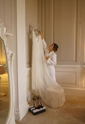 Bridal Portrait - Ana hanging up her wedding dress at Davenport House