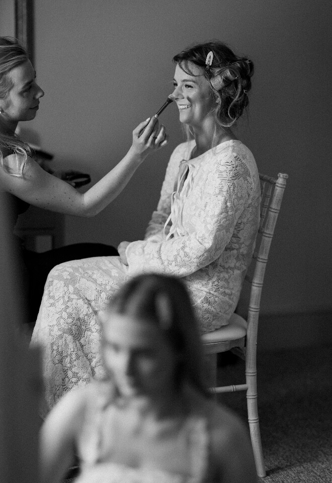 Bride getting make up done on her wedding day
