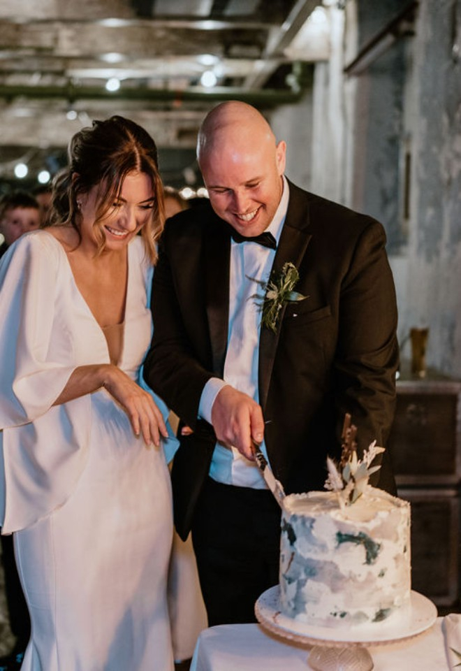 Bride and groom cutting their wedding cake 