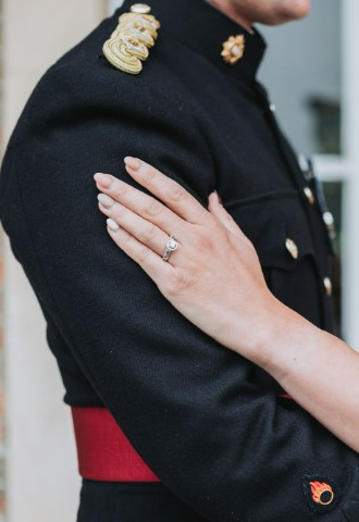 bride and groom in an embrace, bride highlighting her ring from Lovers Rock