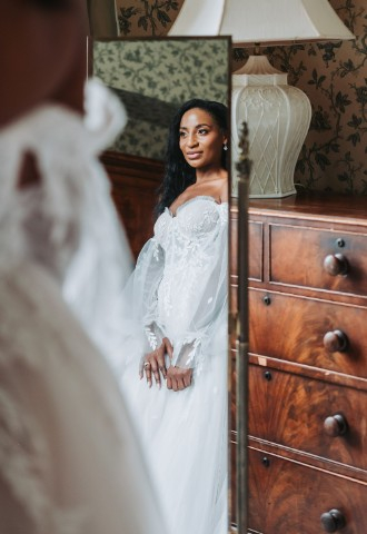 Bridal Portrait - Photo taken through a mirror reflection of the bride in a puff long sleeve wedding dress