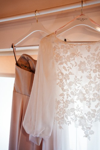 Wedding dress hanging up on wedding morning