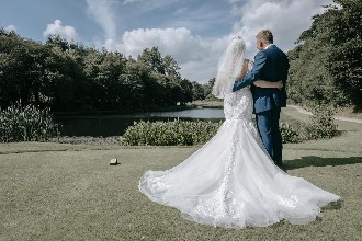 Bride and groom looking out at lake at St Mellion Estate