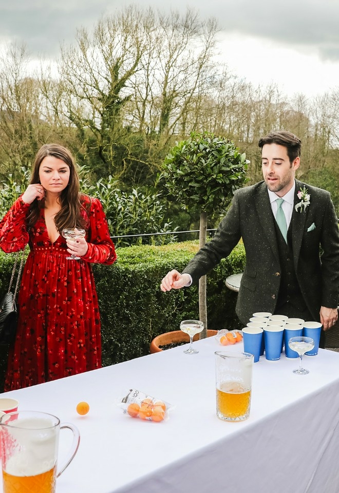 Groom playing beer pong at Mitton Hall wedding