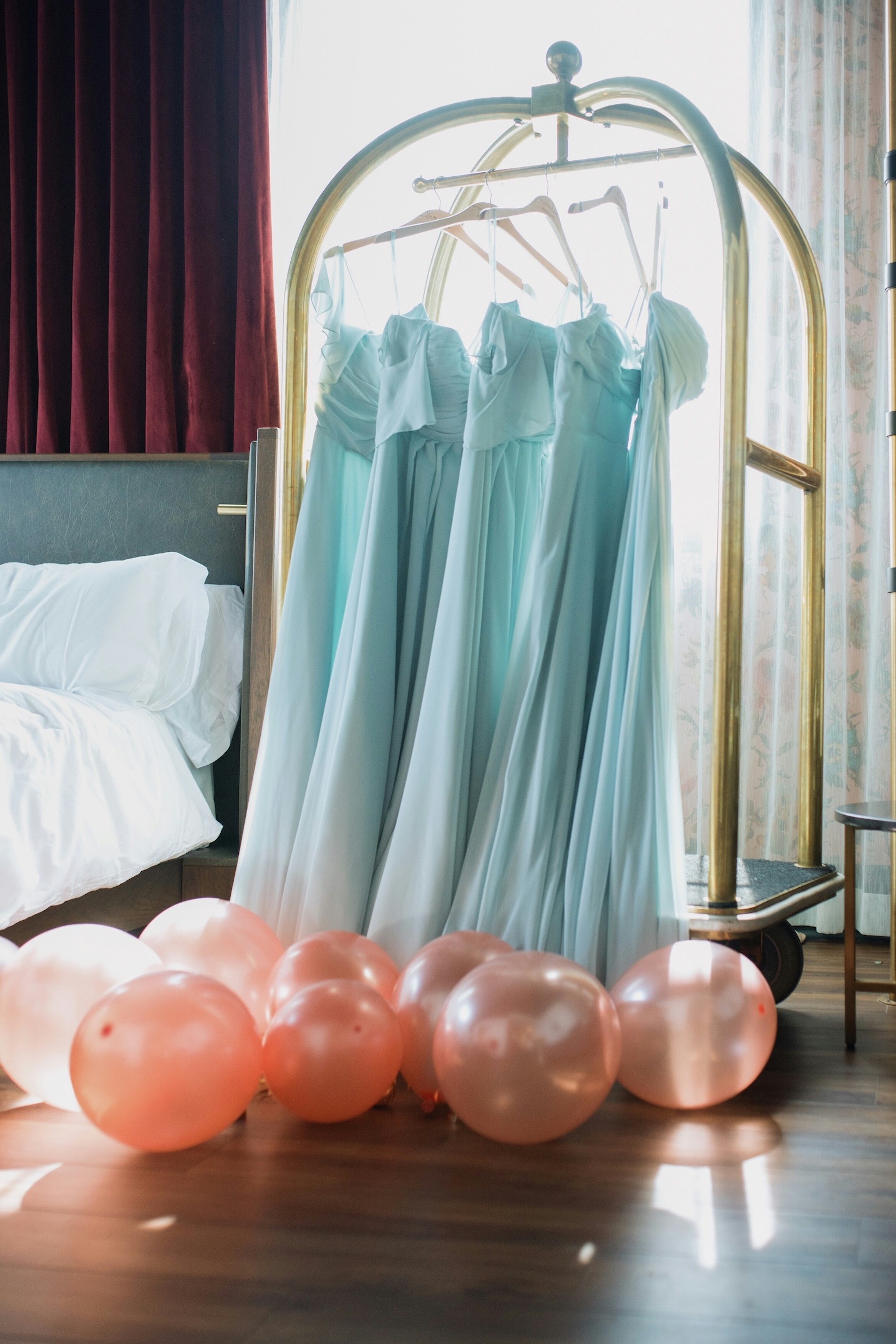 blue dresses hung up on a rail 