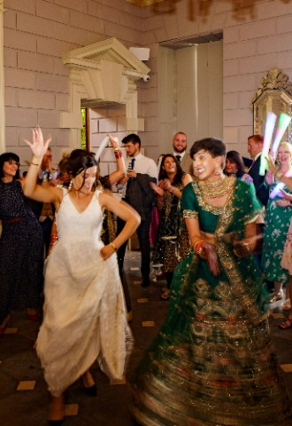Ana and Satveer on the dancefloor at Davenport House, surrounded by their guests.