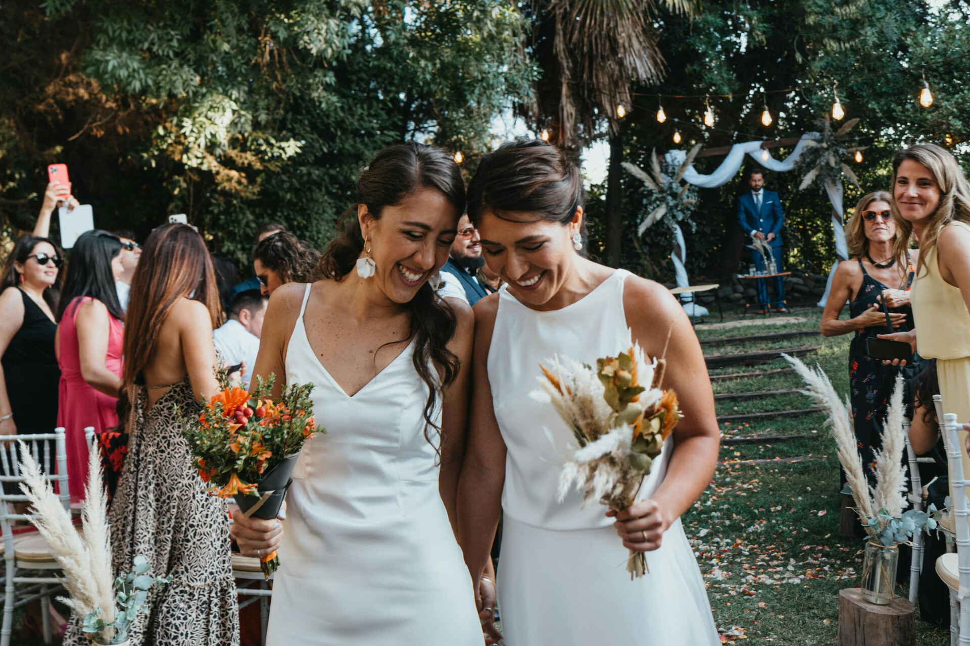 Bride and bride couple celebrating after their outdoor same-sex wedding ceremon
