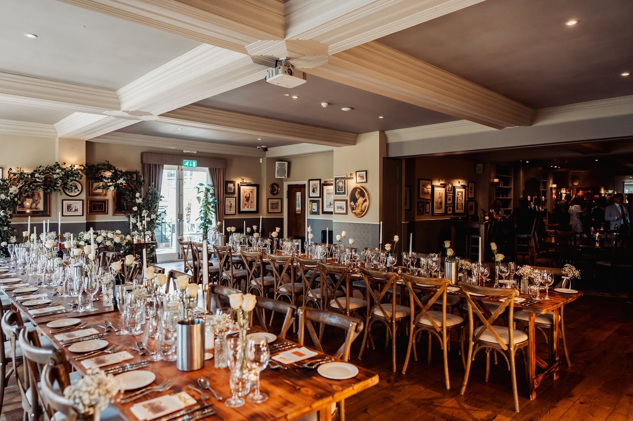 Interior of The Little Fox, a pub venue, set for a wedding breakfast with long tressel tables
