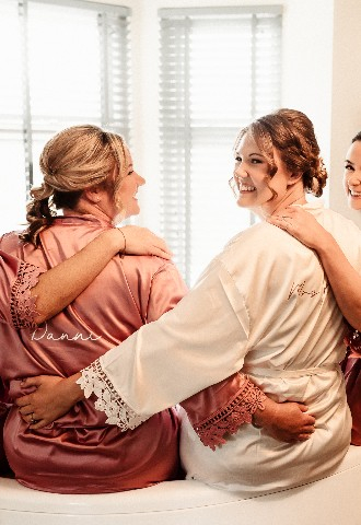Bride and bridesmaid getting ready photo in tub at Southdowns Manor wedding venue