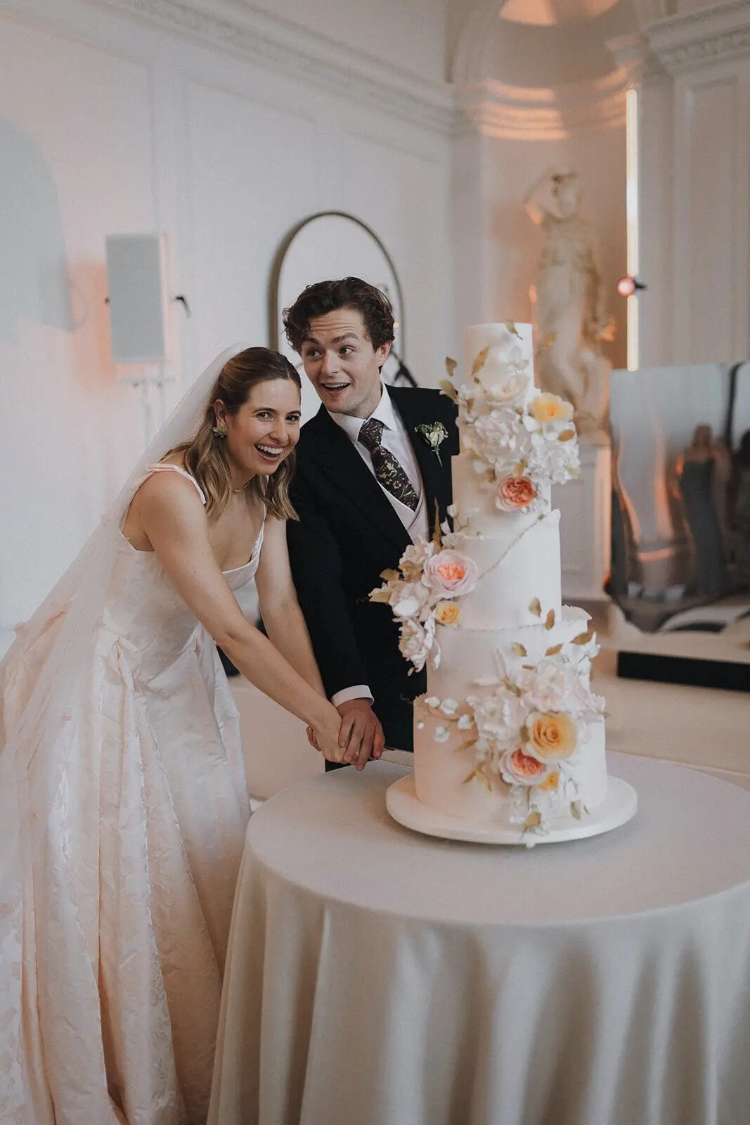 Bride and Groom cutting their 5 tier floral wedding cake, designed by Nicola Hall, owner of Hall of Cakes