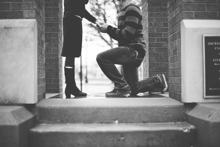 black and white man proposing one knee