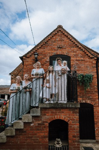 Bride and Her bridesmaids on the steps at Alcott Weddings