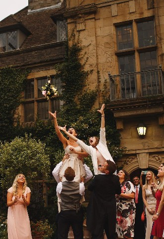 The Traditional Bouquet Toss outside Llangoed Hall in Wales