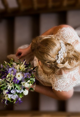 Bride descending stairs carrying bridal bouquet at Trunkwell House, Berkshire wedding photography by Paul Griffiths Photography