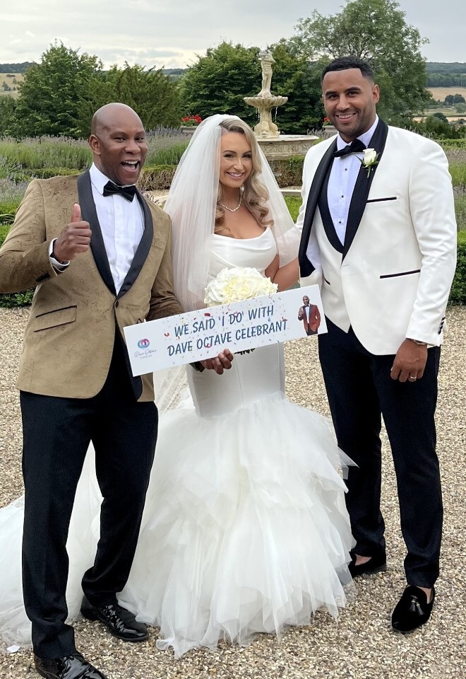 Dave Octave Celebrant with a happy bride and groom smiling and holding my We said I Do with Dave Octave Celebrant sign.