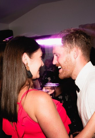 Man and woman laughing at a wedding reception