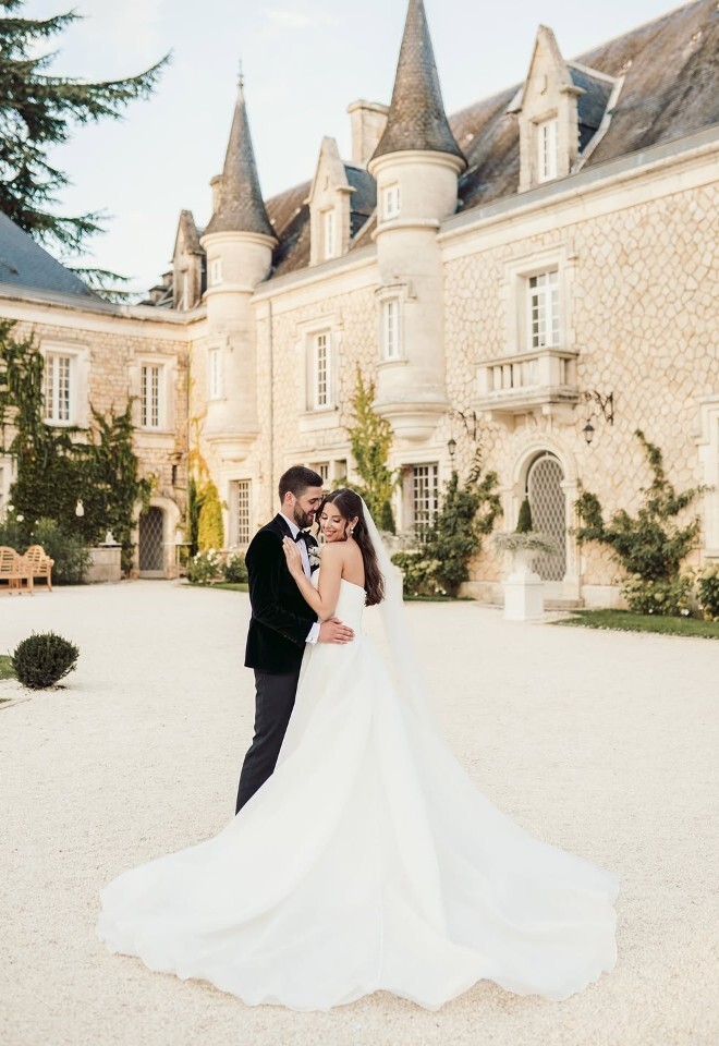 Bride and groom stood in front of the wedding venue taken by Sam Rundle Photography