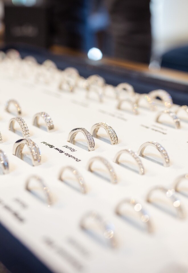 A selection of silver womens wedding rings, with a range of plain bands and pave diamond bands