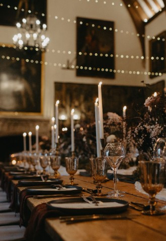 Wedding breakfast lit by candles and fairylights at Berkeley Castle