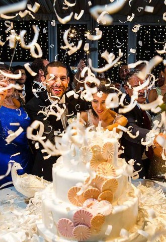 explosion of confetti as the bride and groom cut into their wedding cake