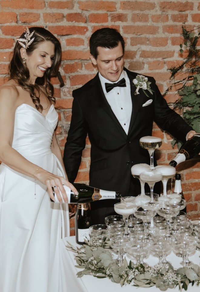 Wedding couple pouring champagne tower at Copdock Hall wedding venue Suffolk