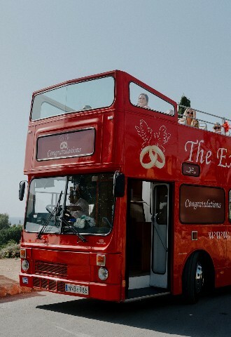 Red double decker guest transport bus in cyprus, exclusive yacht weddings