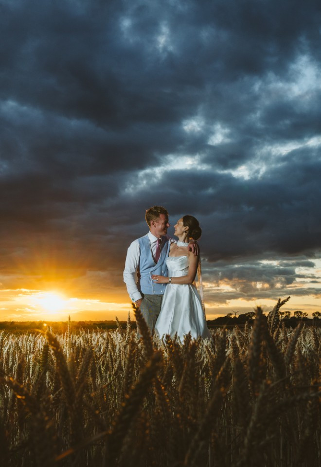 Bride and Groom in a field of wheat during a glorious sunset