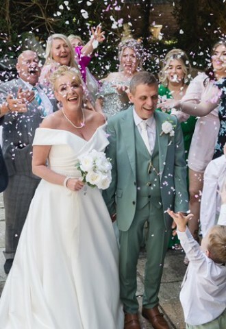 The Bride & Groom surrounded by family and friends at a Commitment Ceremony performed by Pure Silk Ceremonies