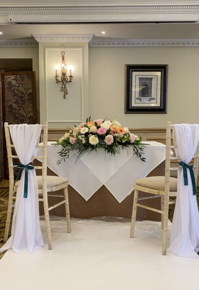 chair sashes & ribbon, top table floral display from hire heaven buckinghamshire