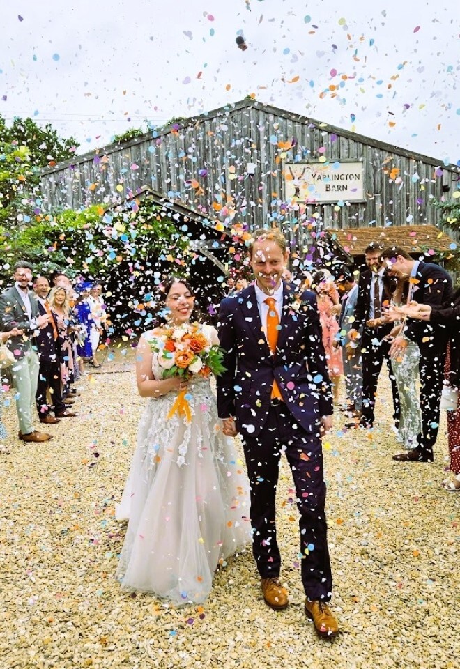 Just Married; Couple walking through confetti at Yarlington Barn