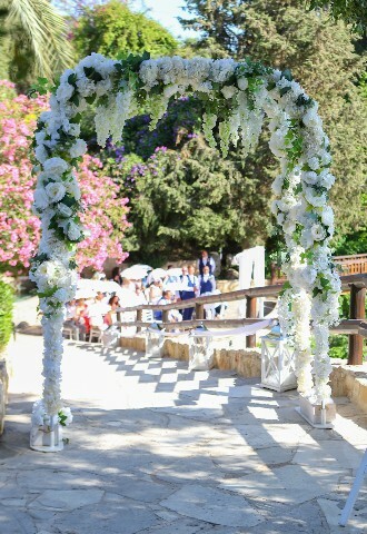 Wedding ceremony entrance with a flower arch in white