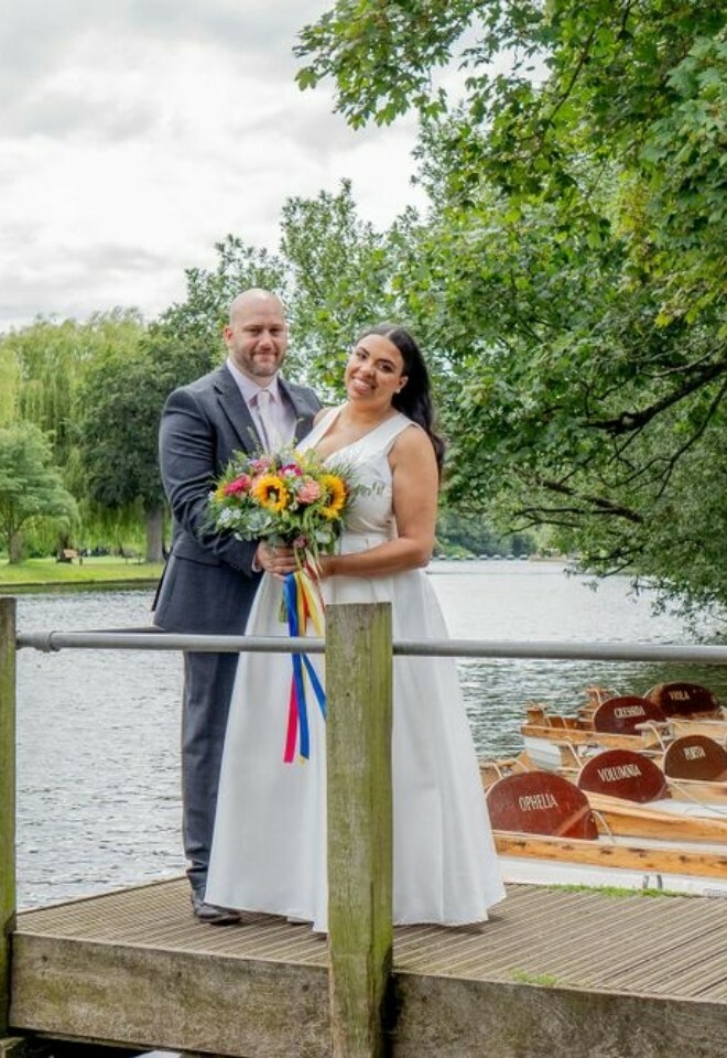 Wed couple beside lake