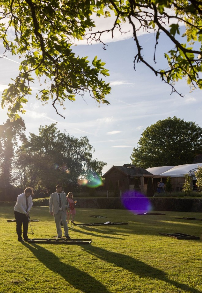 Wedding guests enjoying their time in the garden playing games at a Warwickshire wedding venue