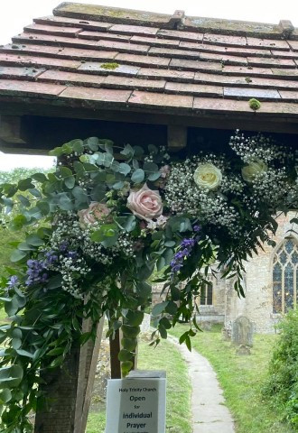 purple, blush and cream floral arch outside a church by ann laing flowers, harwell, oxfordshire