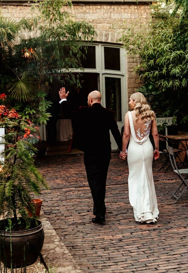 Bride and groom standing holding hands