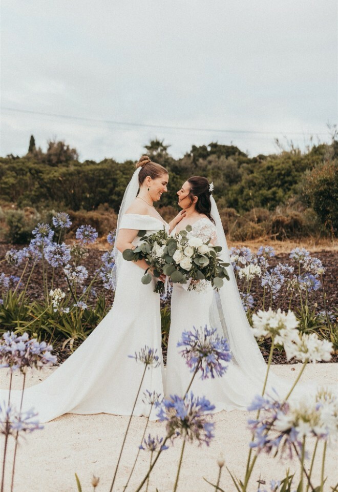 Mrs & Mrs among the Purple Flowers in the Garden of Casa Monte Cristo 