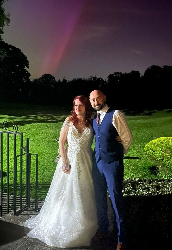 The happy couple with the northern lights in the background