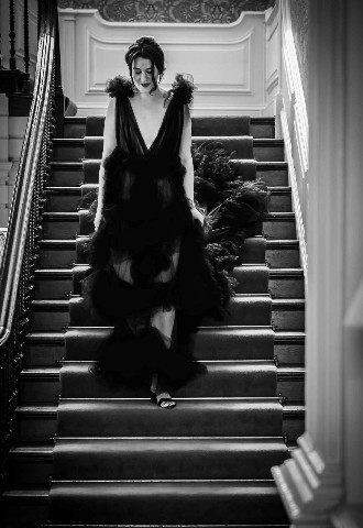 Bride in Black dress walking down stairs at Ardington House