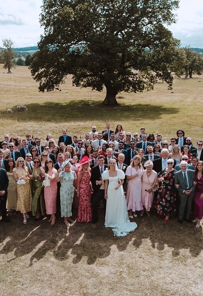 Photo of all wedding guests stood in front of an oak tree at Heathy Lea Derbyshire wedding venue