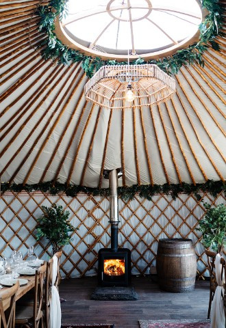 cosy wood-burning stove in 25ft event yurt, intimate wedding venue