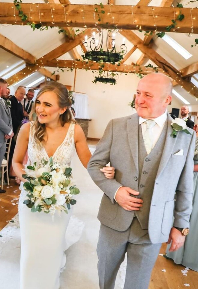 bride walking down the isle with father of the bride meeting the groom