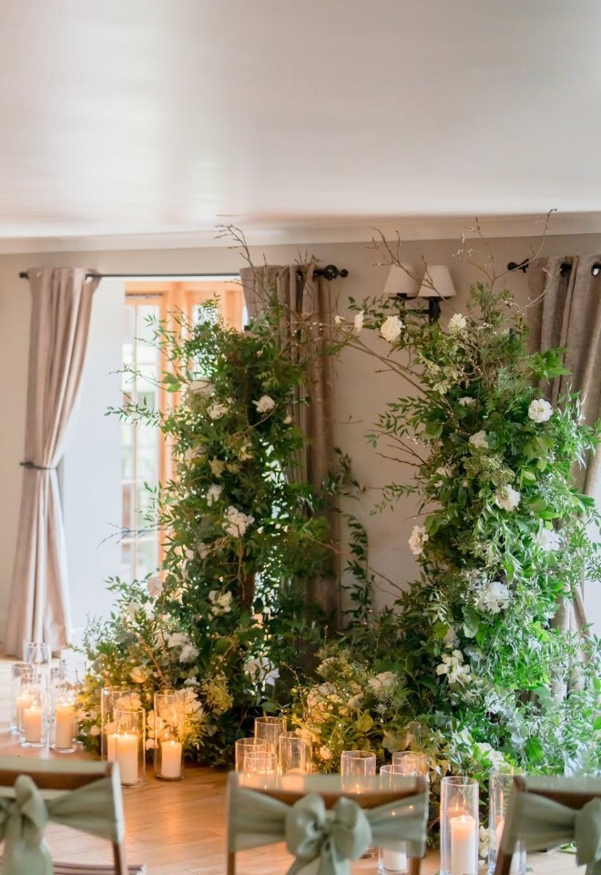 Tottington Manor indoor wedding ceremony with floral arch