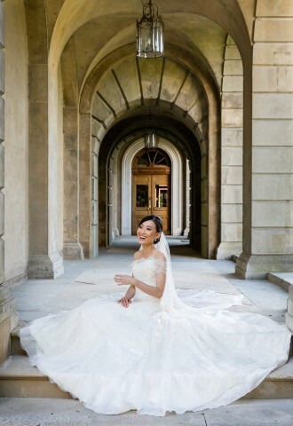 Cliveden Wedding with Bride sitting beneath historic arches