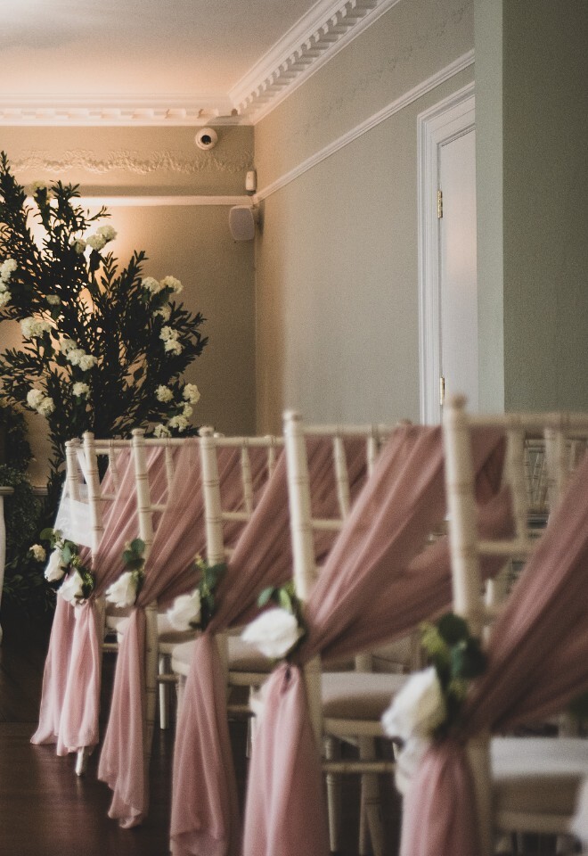 The aisle set up with flowers for a couple at a Warwickshire wedding venue