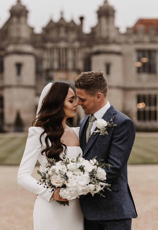 Bride & groom outside the front of Hengrave Hall wedding venue