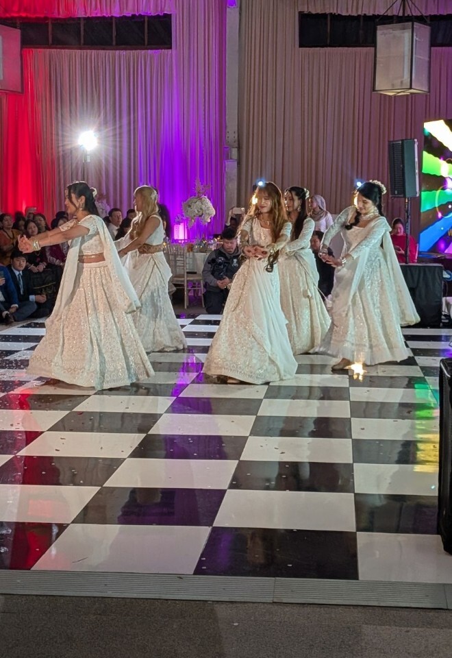 Asian wedding dancing at Briar House Barns barn wedding venue in Rotherfield, East Sussex