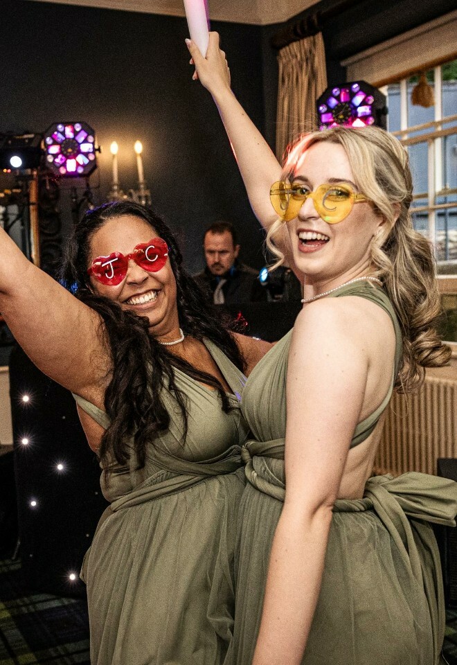 Bridesmaids dancing with heartshaped glasses